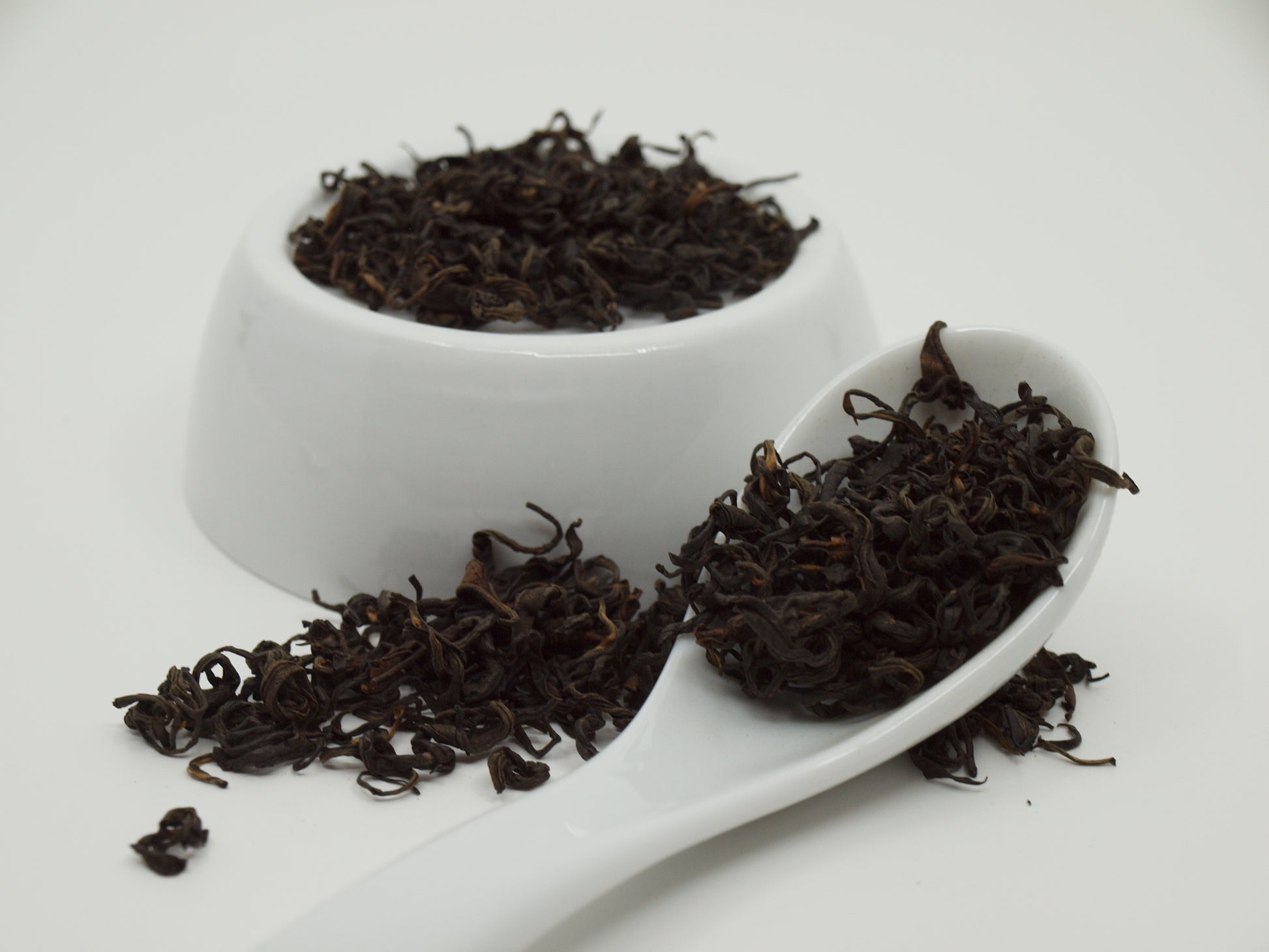 Nepali Oolong Tea resting on a dish and a spoon, close up group shot