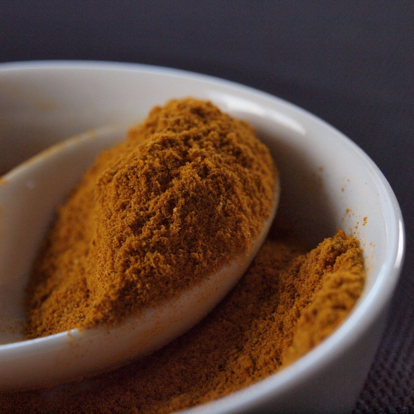 powdered tea, close up of turmeric tea in a white spoon