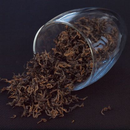 black tea, loose leaf tea, specialty tea, tea falling out of glass